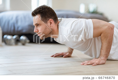 Sporty Man Doing Push-Ups Exercise Training Indoor On Weekend 66746870