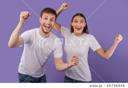 Portrait of cheerful people smiling and clenching fists Portrait of cheerful people smiling and clenching fists 66746946