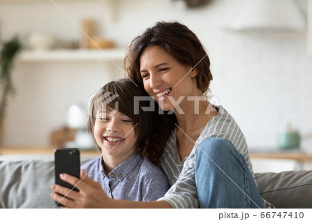 Close up happy young mother taking selfie with preschool son. 66747410