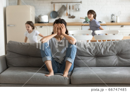Hyperactive kids tired and running near upset mother. Hyperactive kids tired and running near upset mother. 66747485