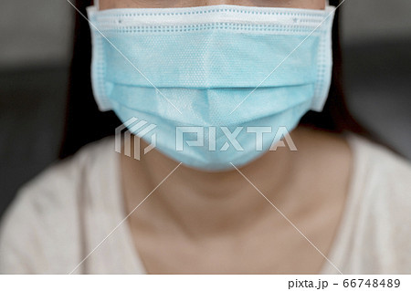 The woman wearing hygienic mask to prevent infection, airborne respiratory illness such as flu. 66748489