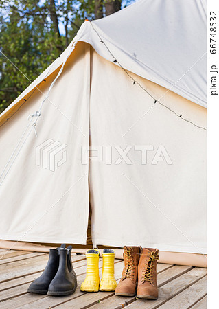 Close-up of glamping bell tent with shoes. Family camping concept 66748532