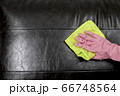 Woman wipe sofa with germicidal spray and wipe with towel. 66748564