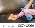 Woman wipe sofa with germicidal spray and wipe with towel. 66748569