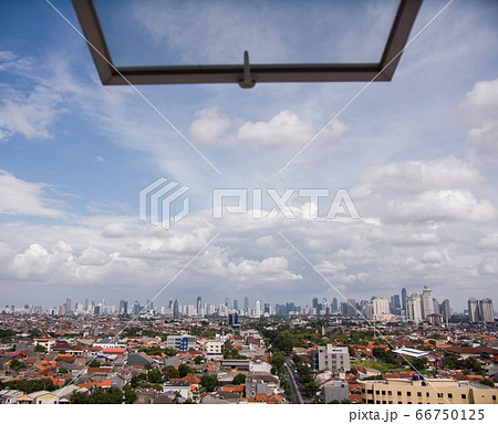 Jakarta city panorama against the background of the window pane. Jakarta city panorama against the background of the window pane. 66750125