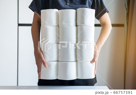 Asian woman hand holding toilet paper during situation coronavirus 19 panic and outbreak at home 66757391