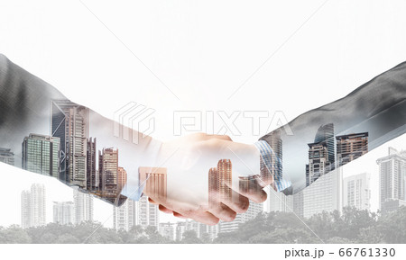 Business handshake as idea for unity and cooperation or greeting. Mixed media 66761330