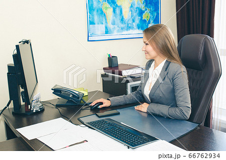 Woman office manager at the desk in the office. Woman office manager at the desk in the office. 66762934