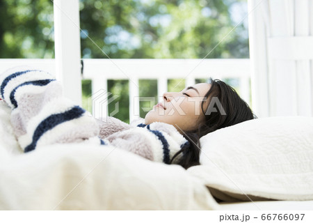 ベットで寝る若い女性のポートレート ベットで寝る若い女性のポートレート 66766097