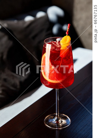 Glass of aperol spritz cocktail on wooden table in 66767135