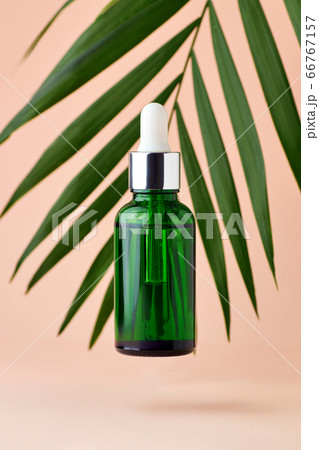 Green dropper with facial oil on background with Green dropper with facial oil on background with 66767157