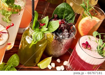 Different cocktails on wooden table 66767181