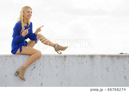 Fashion model wearing blue jumpsuit Fashion model wearing blue jumpsuit 66768274