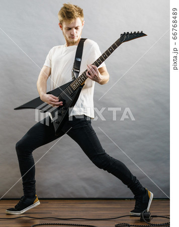 Man playing on electric guitar Man playing on electric guitar 66768489