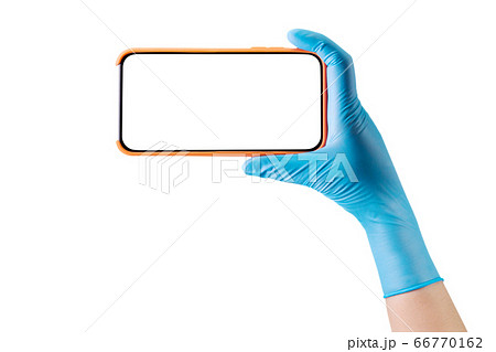Doctor's hand in medical gloves holding phone and 66770162