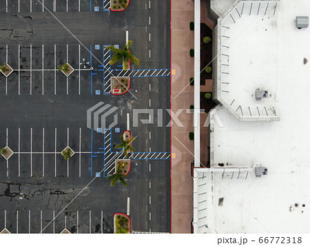 Aerial view of empty shopping center parking lot during COVID-19 pandemic. 66772318