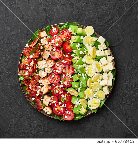 Cobb Salad on black slate table top. USA food and meal. American cuisine dish Cobb Salad on black slate table top. USA food and meal. American cuisine dish 66773418