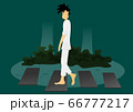 a guy walk peacefully in garden 66777217