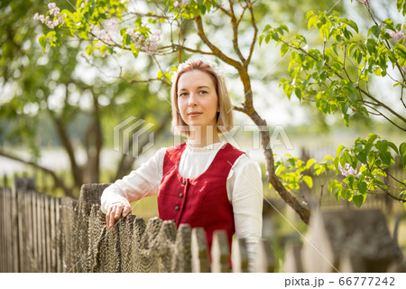 Latvian woman in traditional clothing. Ligo folk. 66777242