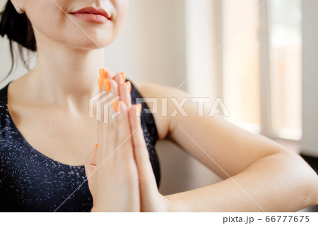 Young woman doing yoga meditating on fitness mat Young woman doing yoga meditating on fitness mat 66777675