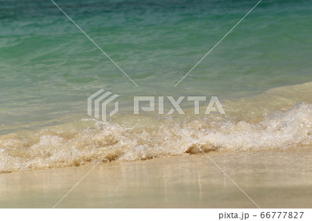 Wave of the sea swashing up onto sand beach, 66777827
