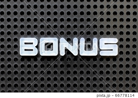 White color alphabet with word bonus on black pegboard background White color alphabet with word bonus on black pegboard background 66778114