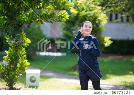 Portrait of Asian woman running at village park Portrait of Asian woman running at village park 66778222