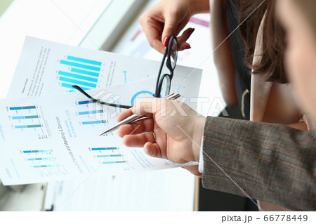 Business colleagues discussing statistics report at work 66778449