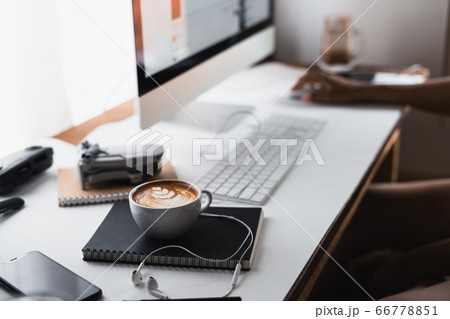 Hot coffee in a cup at the computer desk 66778851