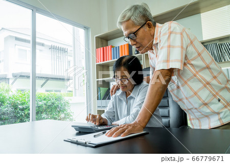 Senior Asian couple using the calculator and 66779671