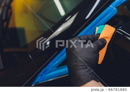 Car detailing - Man applies nano protective coating to the car. Selective focus. 66781880