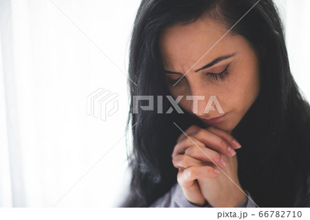 Portrait of woman praying 66782710