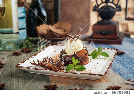 Chocolate fondant with ice cream mint and garnish Chocolate fondant with ice cream mint and garnish 66783991