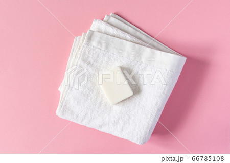 Towel with soap on a pink background Towel with soap on a pink background 66785108