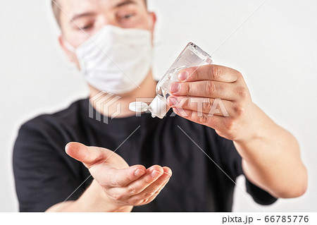 Young man hands holding antibacterial rubbing gel 66785776