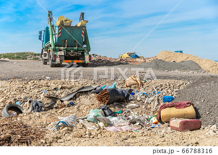 the garbage truck brought the waste to the landfill 66788316
