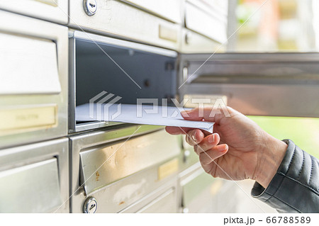letter in the mailbox of an apartment building 66788589