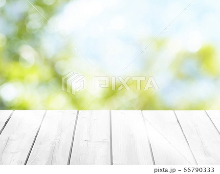 Wooden table on blurred nature green background 66790333
