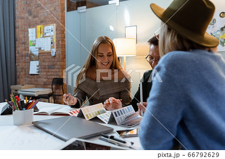 a group of young designers gathered in the evening in the office to discuss ideas 66792629