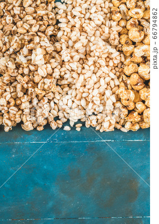 Popcorn and caramel corns on a blue background Popcorn and caramel corns on a blue background 66794862