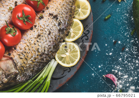 Fish with lemon, tomato and chopped herbs 66795021