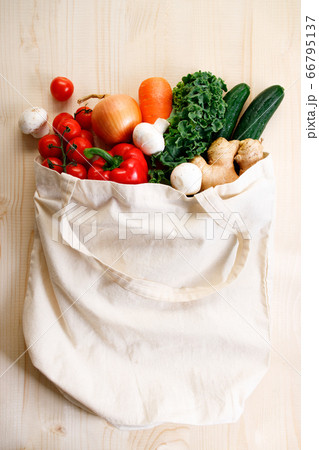 Fresh vegetables in cloth bag on light wooden 66795137