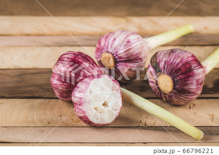 Small pink garlic gloves on a wooden table 66796221