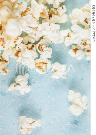 Fresh popcorns spread over the blue table Fresh popcorns spread over the blue table 66796965
