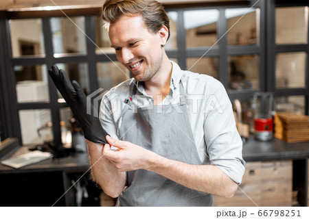 Salesman wearing gloves in the cafe 66798251
