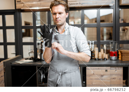 Salesman wearing gloves in the cafe 66798252