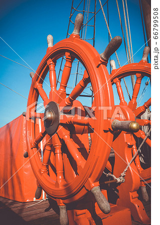 Red wheel helm on antique ship Red wheel helm on antique ship 66799508