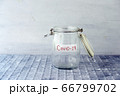 Empty money jar with covid19 label 66799702