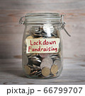 money jar with lockdown fundraising label. 66799707