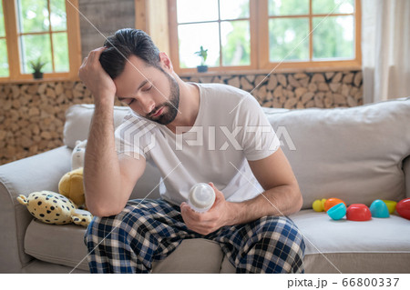 Young happy father sitting on the sofa feeling tired Young happy father sitting on the sofa feeling tired 66800337